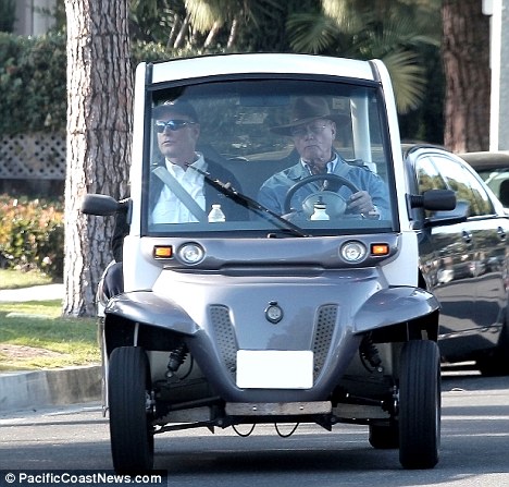 Drink driving: Larry Hagman drives an electric golf buggy home after drinking wine at lunch with his friend